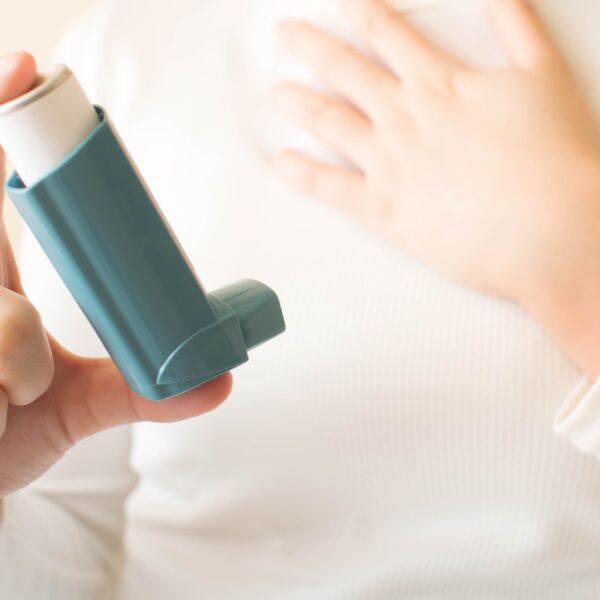 A woman taking a puffer for asthma