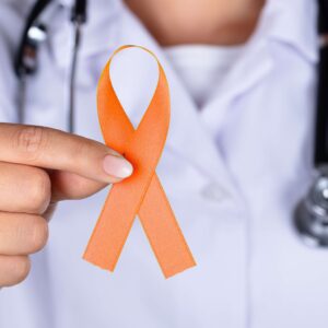 A doctor holding a ribbon for multiple scerosis