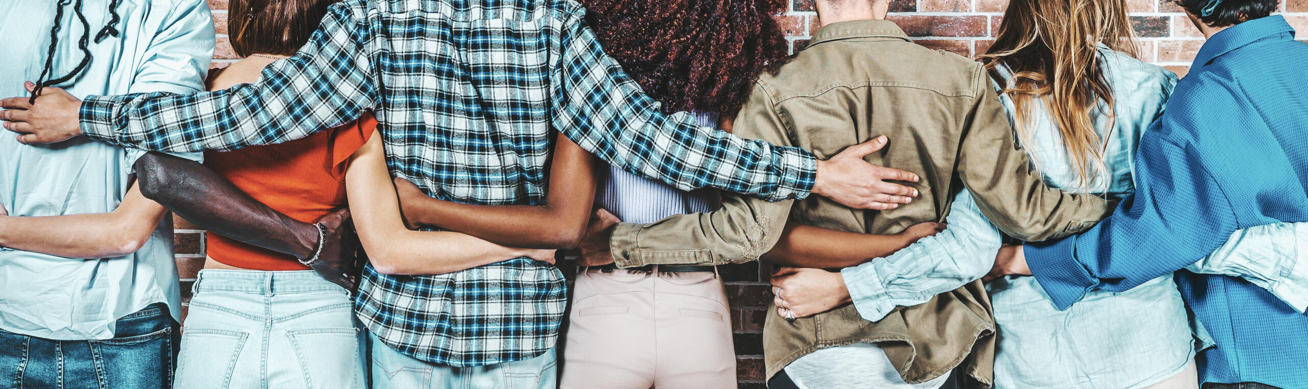 Back view of group of diverse people hugging each other - Support, help and youth community concept