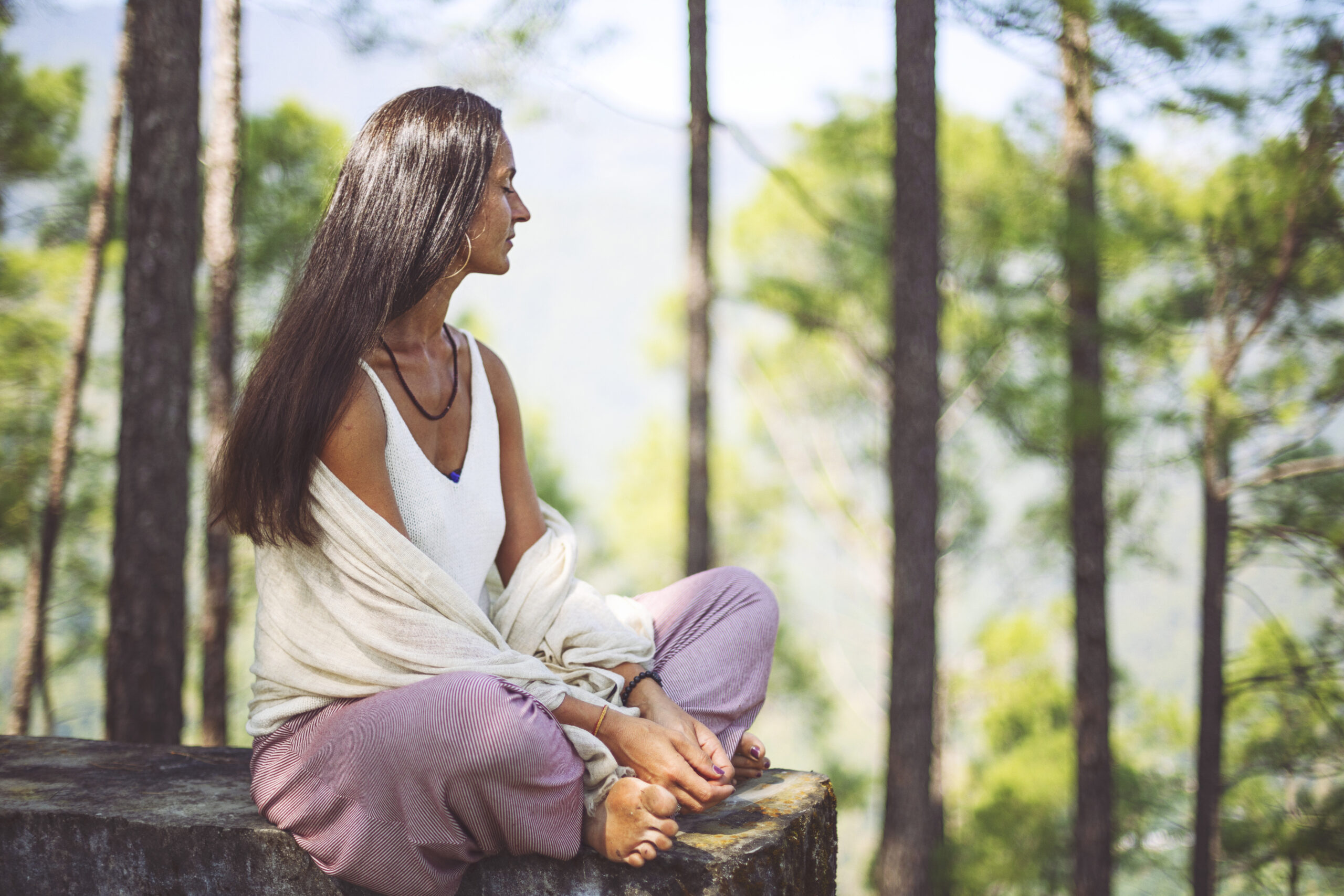 Spiritually beautiful black haired woman meditates in a temple complex in northern India