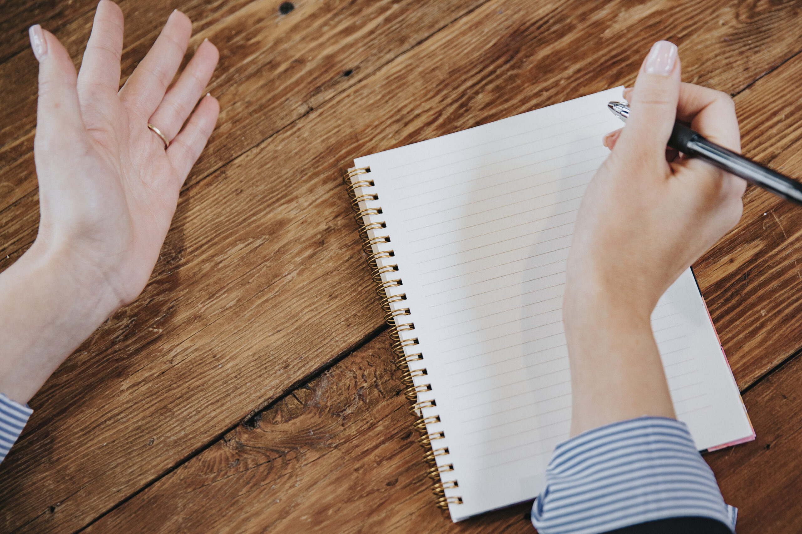 Businesswoman writing on a notebook mockup